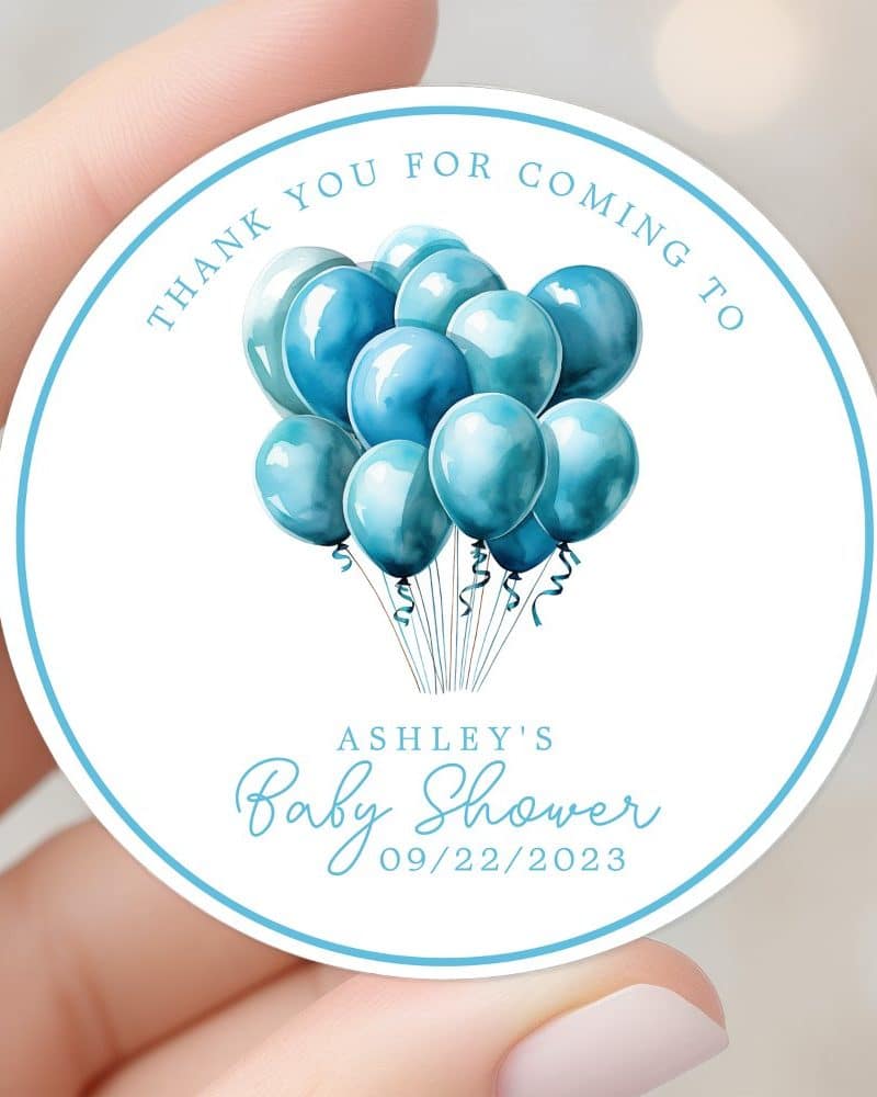 Round baby shower thank you sticker featuring blue watercolor balloons and Ashley's baby shower date.