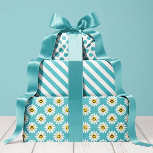 Stack Of Three Teal Wrapped Gifts With A Large Teal Bow. The Gifts Are Decorated With Different Patterns.