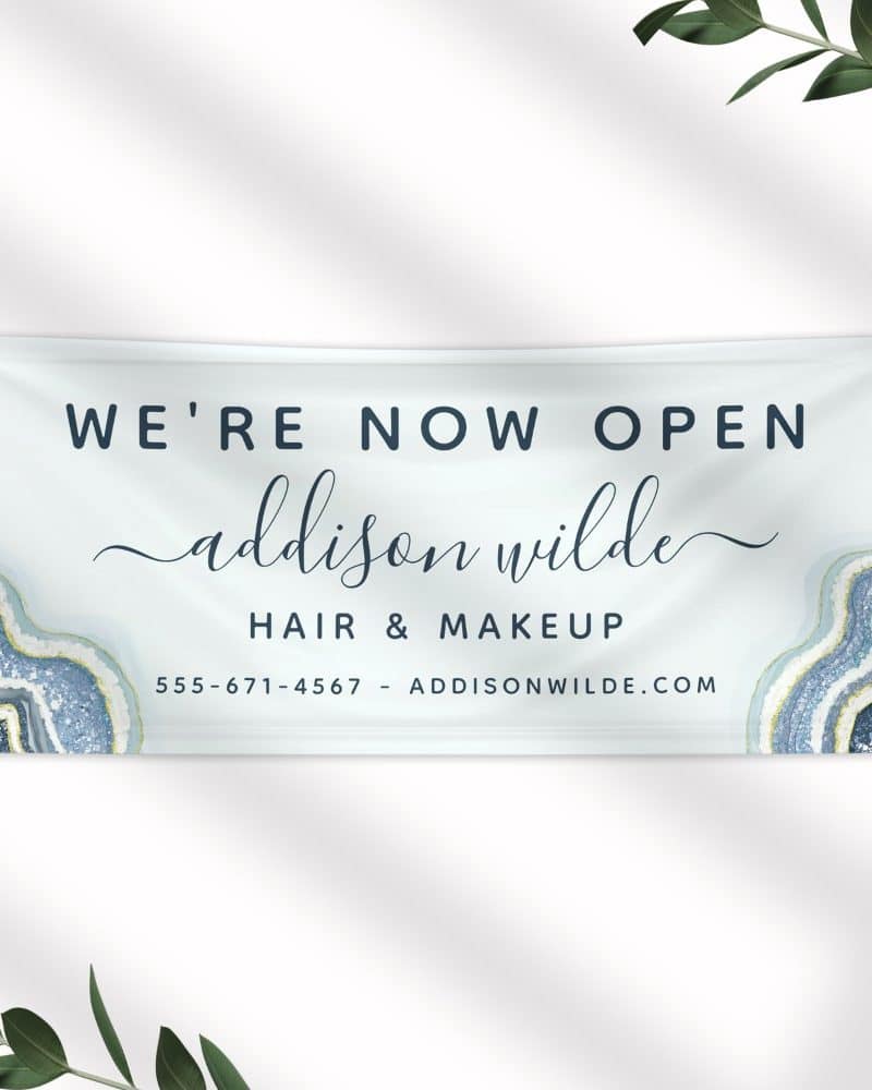 A grand opening banner for Addison Wilde Hair & Makeup. The banner features a light blue agate design.