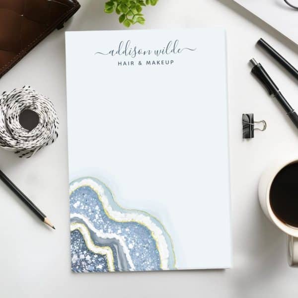 A Notepad Featuring A Blue And Gold Agate Design And The Text Addison Wilde Hair &Amp; Makeup.