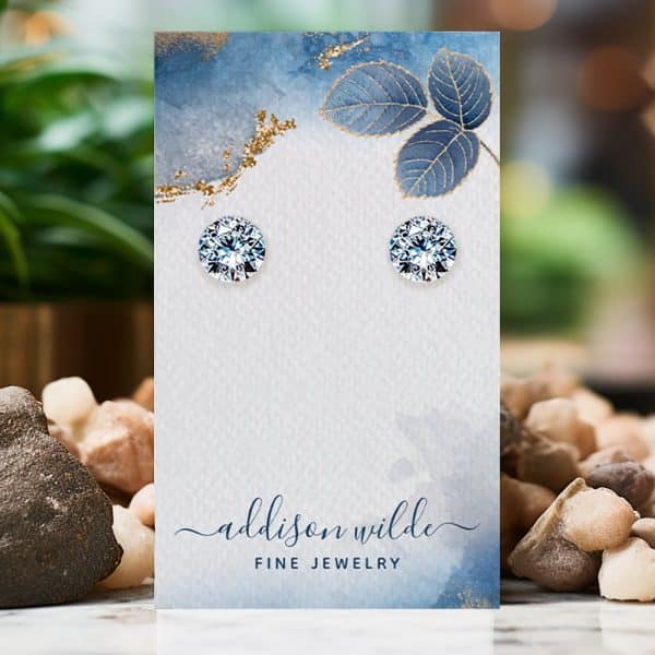 Pair Of Round, Clear Stud Earrings Displayed On A Card.