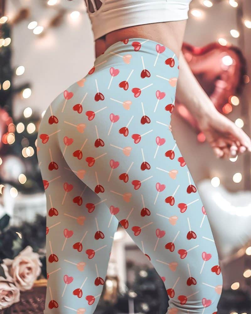Light blue leggings with a pattern of red and pink heart-shaped lollipops.