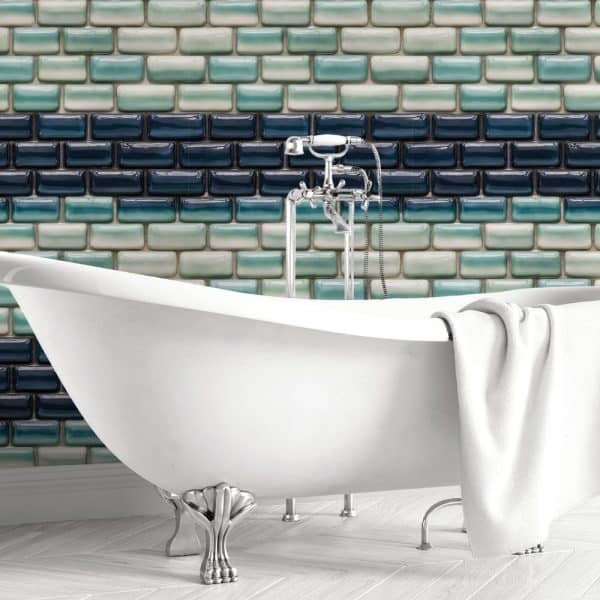 White Clawfoot Bathtub In Front Of A Teal And Blue Ombre Tile Wall.