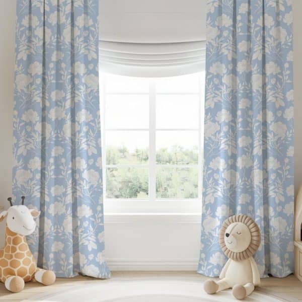 Light Blue Curtains With A White Floral Pattern Hang On A Window.