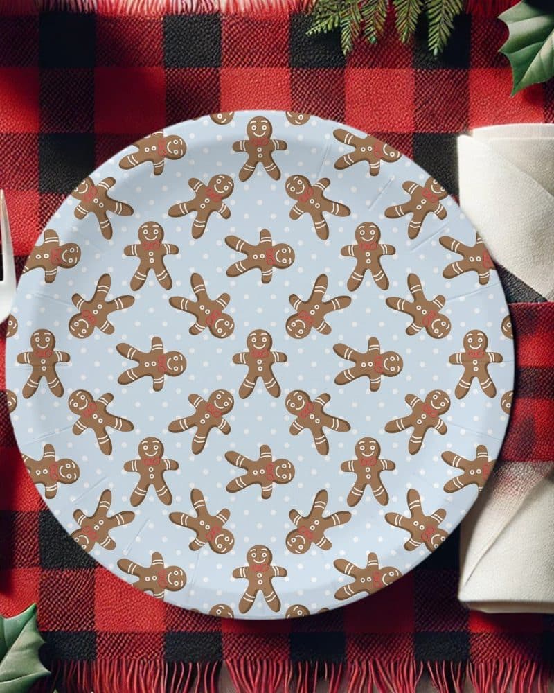 A light blue paper plate decorated with a repeating pattern of gingerbread men.