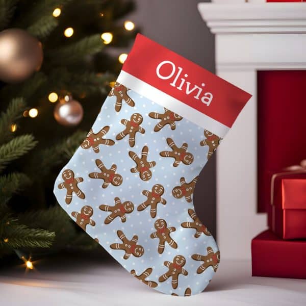 Personalized Christmas Stocking With A Light Blue Gingerbread Man Pattern And The Name Olivia.