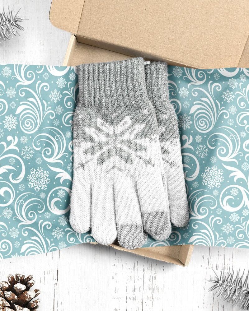 Pair of grey and white snowflake patterned gloves in a gift box.