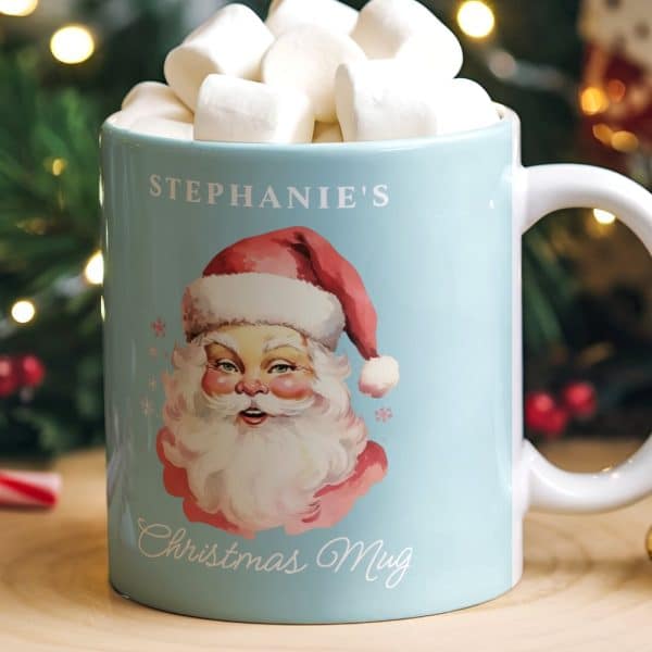 Light Blue Mug With Santa Claus Illustration And Personalized Name, Filled With Marshmallows.