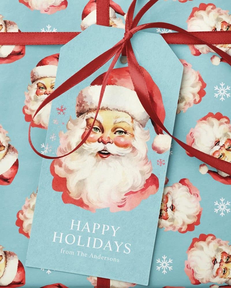 A gift tag with a vintage Santa illustration and the text Happy Holidays from The Andersons.