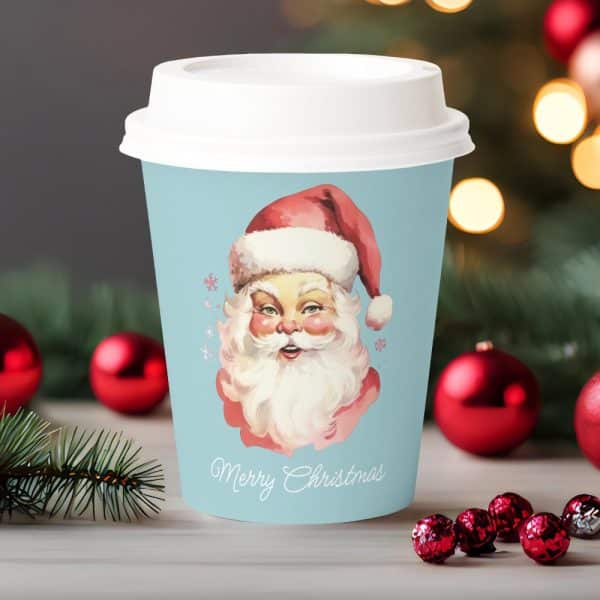A Light Blue Christmas Coffee Cup Featuring A Vintage Illustration Of Santa Claus. Merry Christmas Is Written Below.