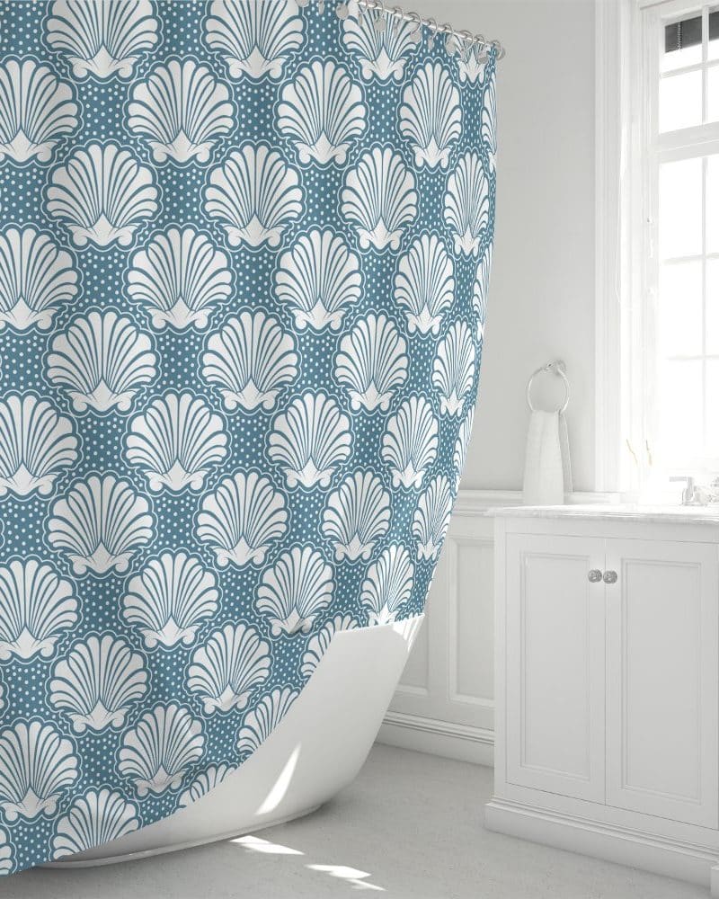 A teal shower curtain with a white seashell pattern.