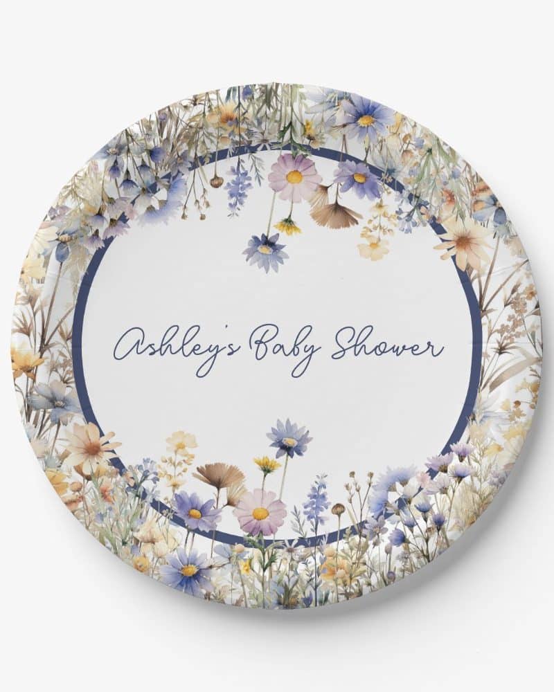 Round paper plate with a navy blue circular border featuring watercolor wildflowers and the text Ashley's Baby Shower.