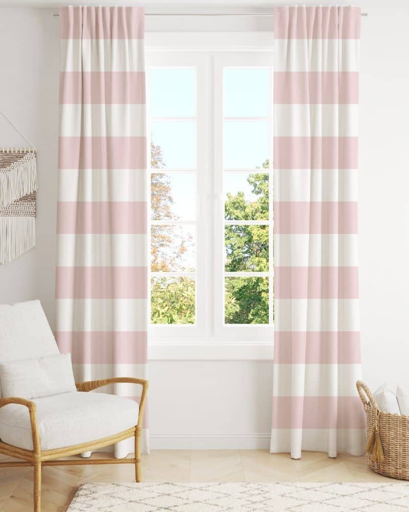 Pink and white striped curtains hanging in a window.
