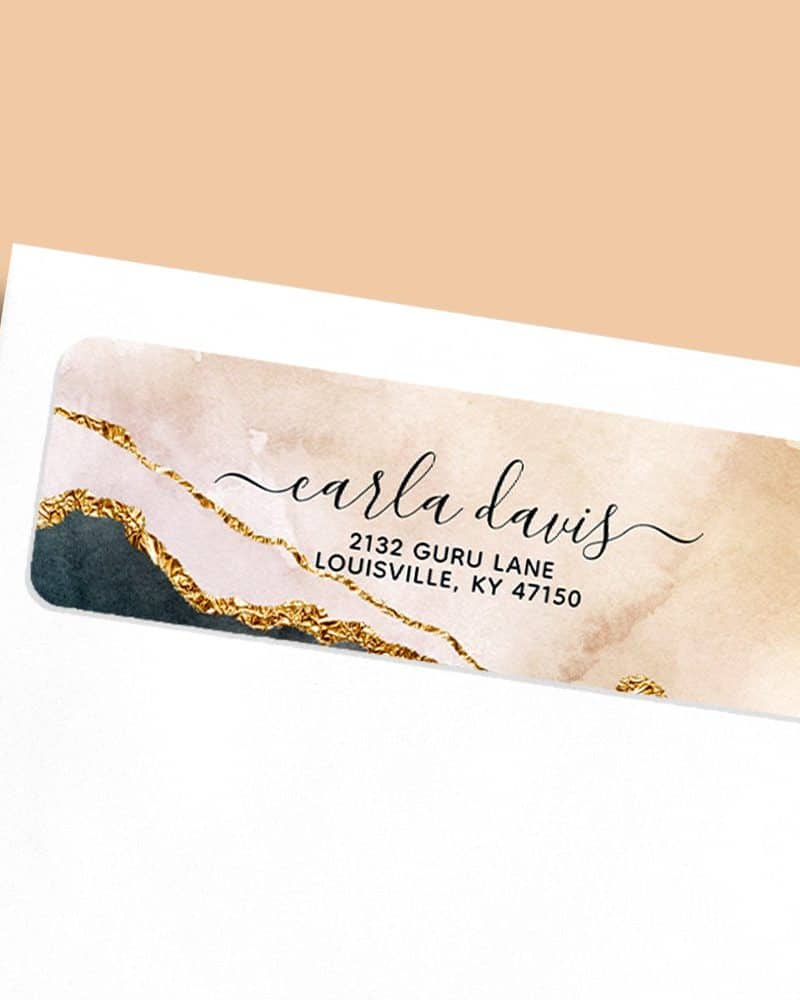 Return address label with gold and blush watercolor design, featuring Carla Davis's name and address.
