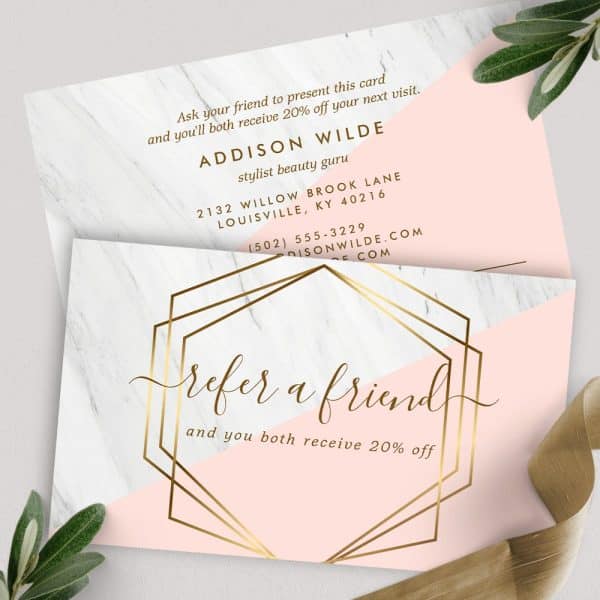 Refer A Friend And Receive 20% Off Your Next Visit. A Pink And White Card With Gold Geometric Design.