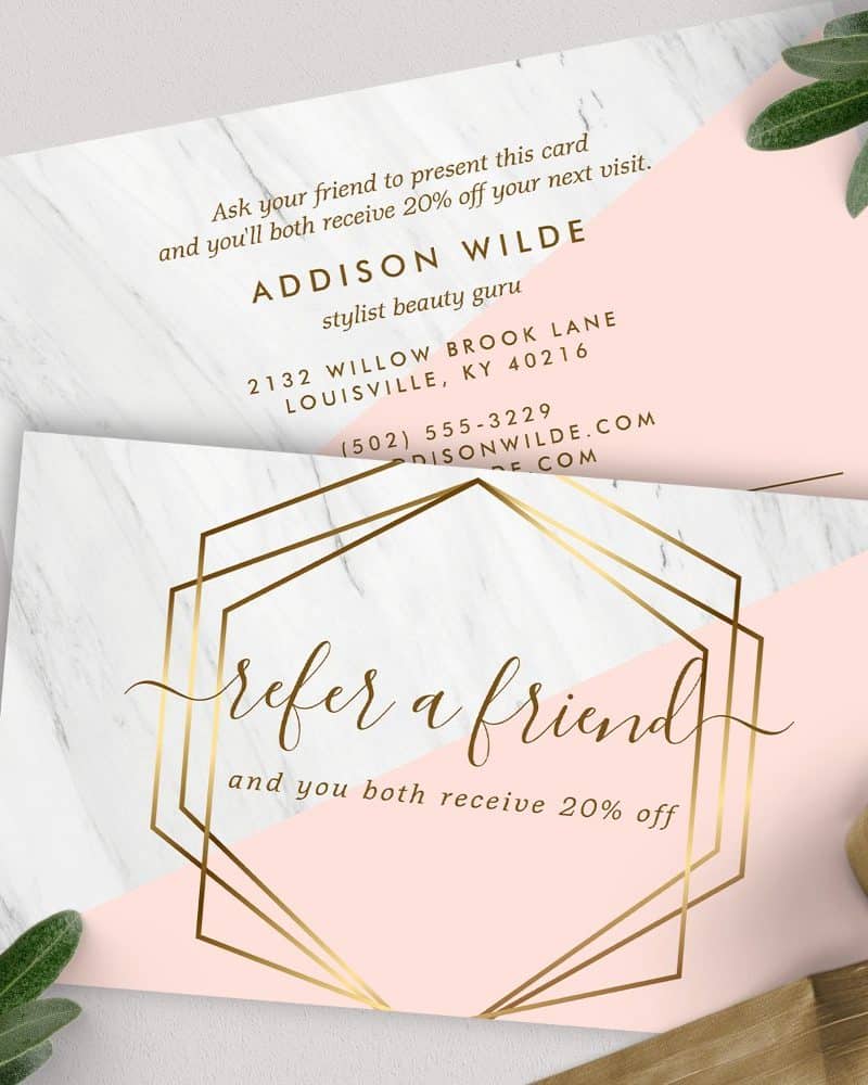 Refer a friend and receive 20% off your next visit. A pink and white card with gold geometric design.