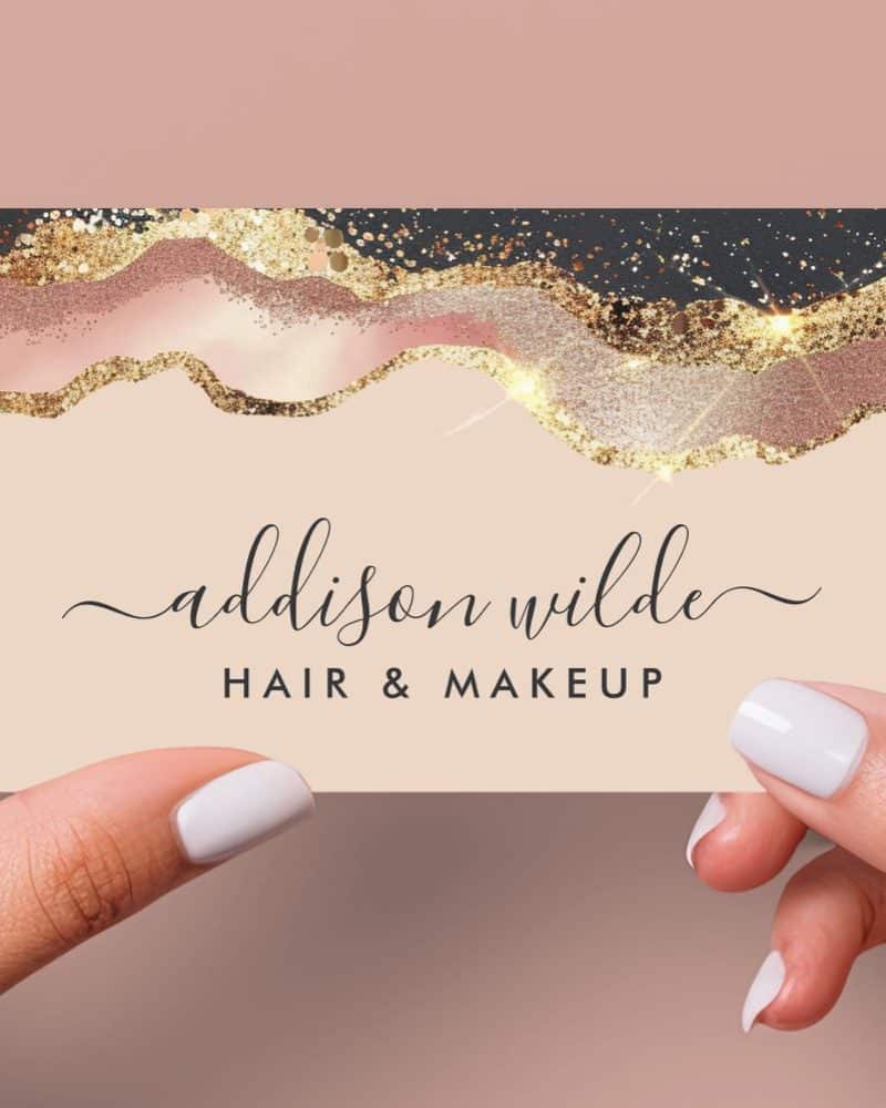A business card for Addison Wilde Hair & Makeup. The card features a design of rose gold and black glitter accents.