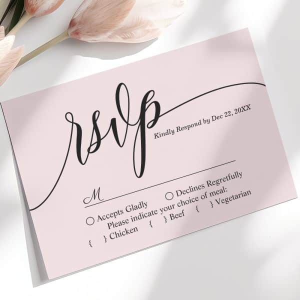 A Light Pink Rsvp Card With Elegant Black Script Lettering.