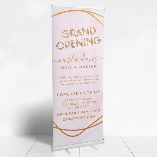 Grand Opening Retractable Banner For Carla Davis Hair &Amp; Makeup. The Banner Features A Pink Watercolor Design With Gold Accents. Contact Information And Daily Hours Are Included.