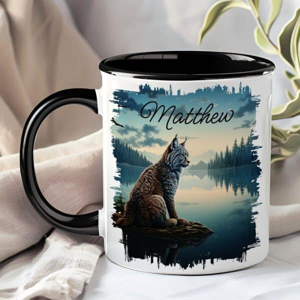 Black-Handled Mug With A Lynx Sitting By A Lake At Sunset; The Name Matthew Is Printed On The Mug.