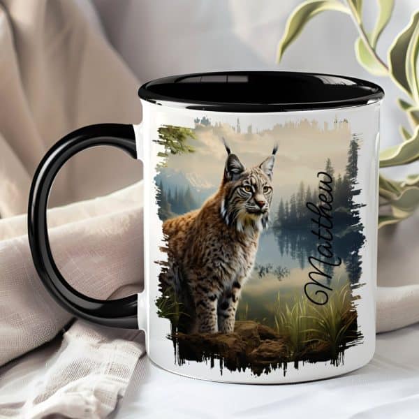 A Black And White Coffee Mug Featuring A Lynx In A Forest Landscape. The Name Matthew Is Printed On The Mug.