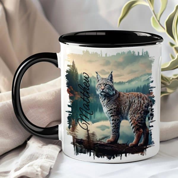 A Black-Handled Mug Features A Lynx Standing On A Branch In A Mountain Landscape. The Name Matthew Is Printed On The Mug.