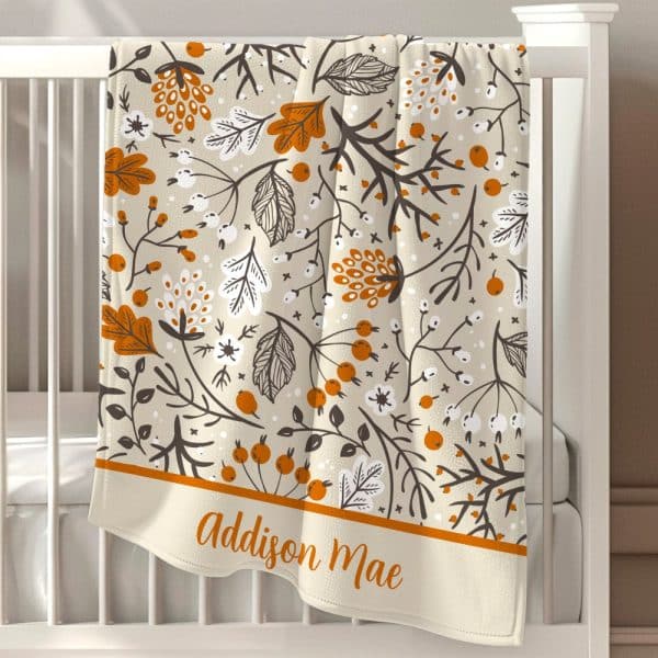 Beige Baby Blanket With An Orange And Brown Floral Pattern And The Name Addison Mae At The Bottom.