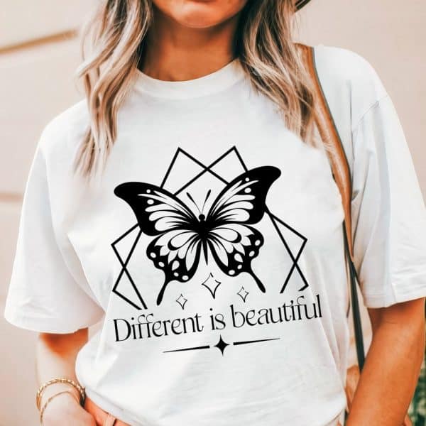 White T-Shirt Featuring A Black Butterfly Graphic Within A Geometric Design, And The Text Different Is Beautiful.
