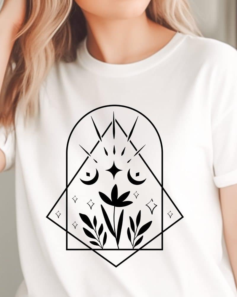 White t-shirt with a black geometric design featuring a flower, crescent moons, and stars.