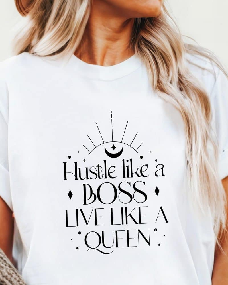 White t-shirt with the text Hustle like a Boss Live like a Queen. A crescent moon and sunburst graphic is above the text.