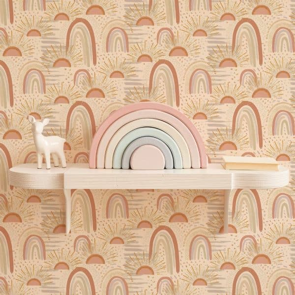 Pastel Rainbow Stacking Toy On Shelf Against A Wall With A Repeating Pattern Of Rainbows And Sunbursts.