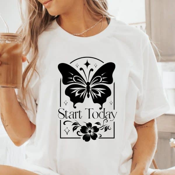 White T-Shirt With A Black Butterfly Design, A Flower, And The Words Start Today.