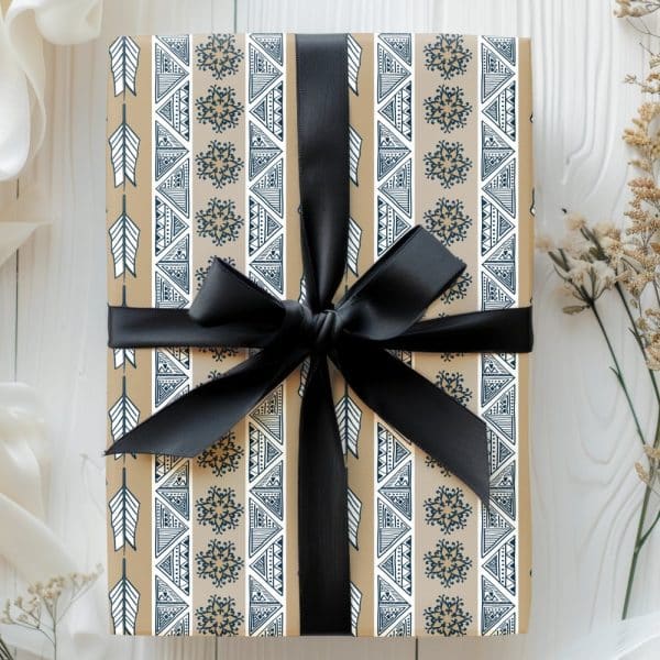 Tan Gift Box With A Navy And White Geometric Pattern, Tied With A Black Ribbon.
