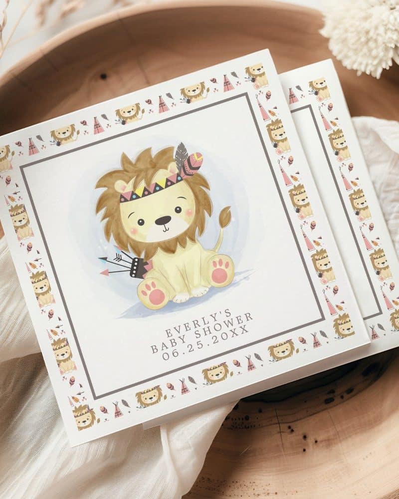Baby shower invitation featuring a cute cartoon lion wearing a headdress.