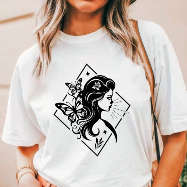 White T-Shirt With A Black Graphic Design Of A Woman'S Profile, Adorned With Butterflies.