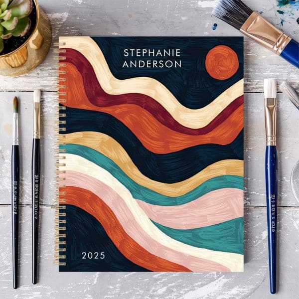 2025 Spiral Bound Planner With Abstract Paint Stroke Design In Autumnal Colors, Personalized With The Name Stephanie Anderson.