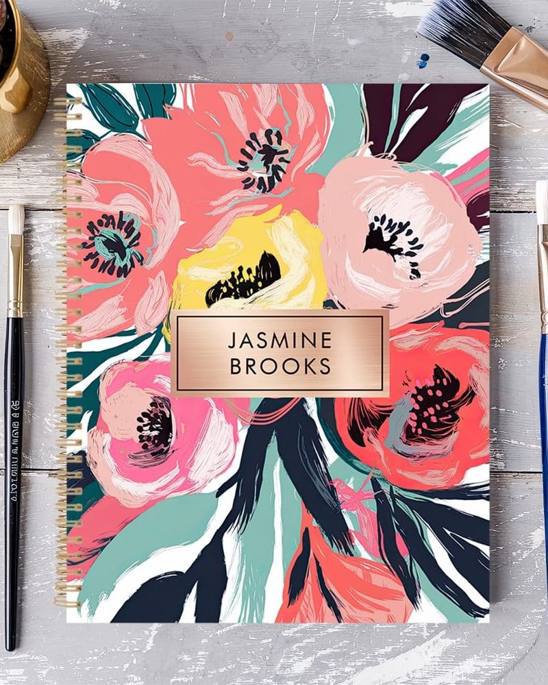 Spiral-bound notebook with a floral design and the name Jasmine Brooks.