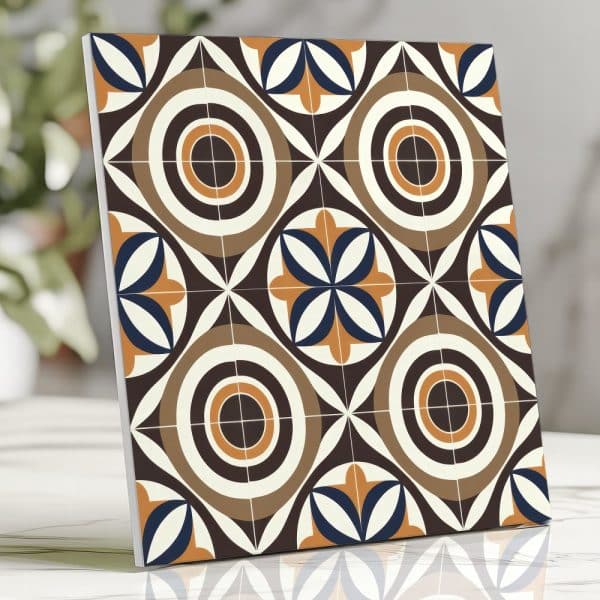 Square Tile Sample With Repeating Geometric Pattern In Brown, Orange, And Blue.