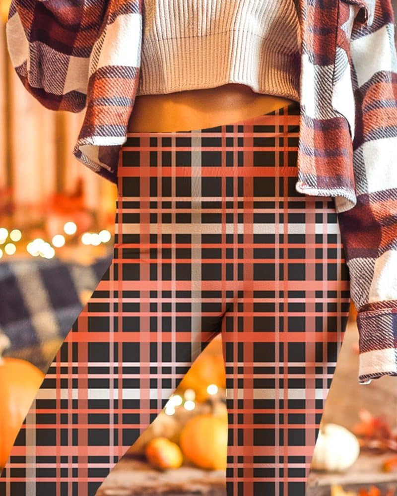 Close-up of a person wearing black and coral plaid leggings.
