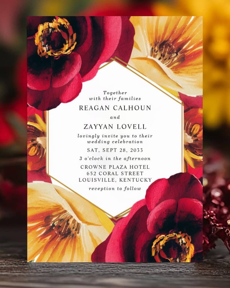 Wedding invitation with red and yellow floral design.