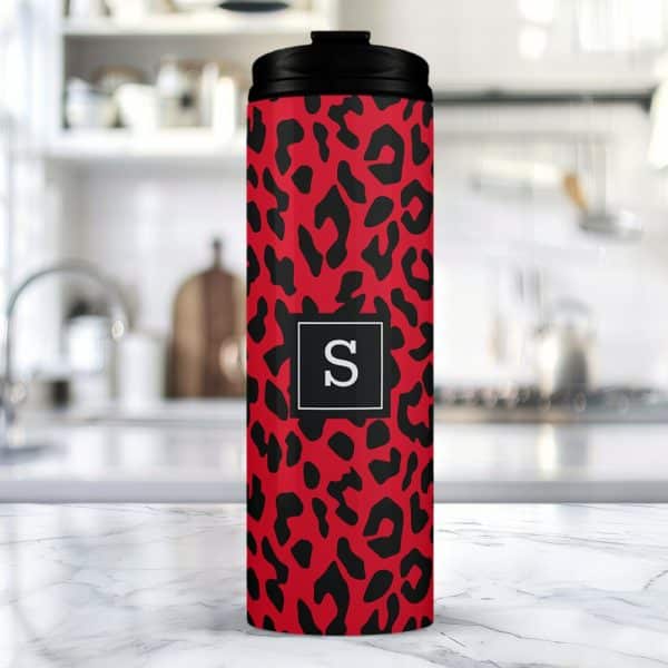 Red And Black Leopard Print Travel Tumbler With A Black Lid And The Letter S In A Gray Square.