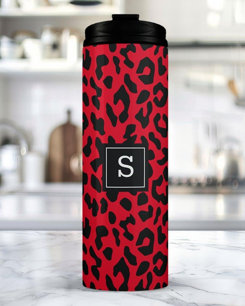Red and black leopard print travel tumbler with a black lid and the letter S in a gray square.