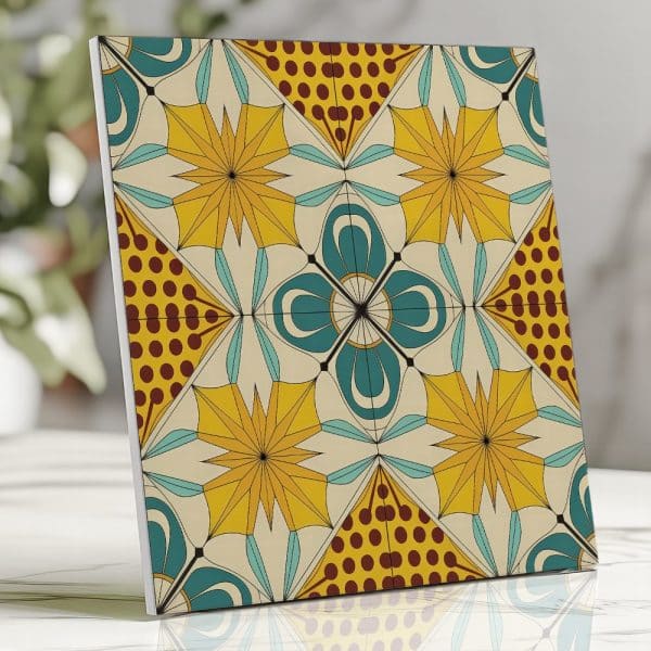 Square Tile With A Repeating Geometric Floral Pattern In Yellow, Teal, And Brown.