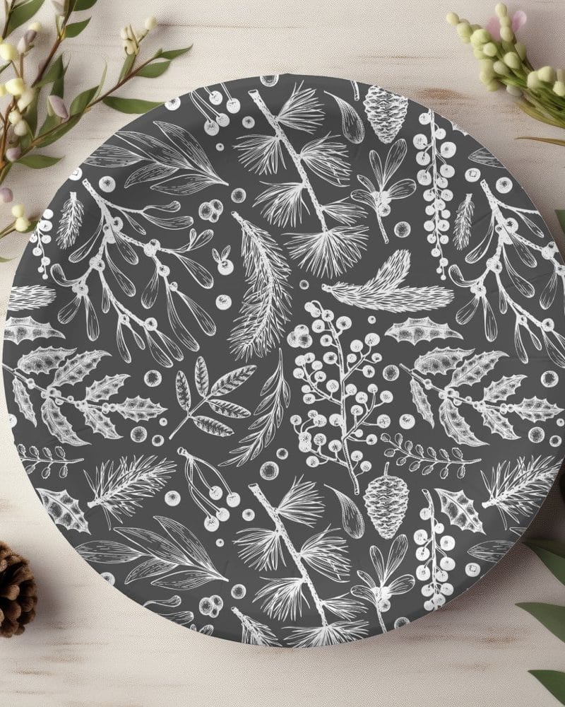 Dark gray round plate with a white illustrated holiday botanical pattern.