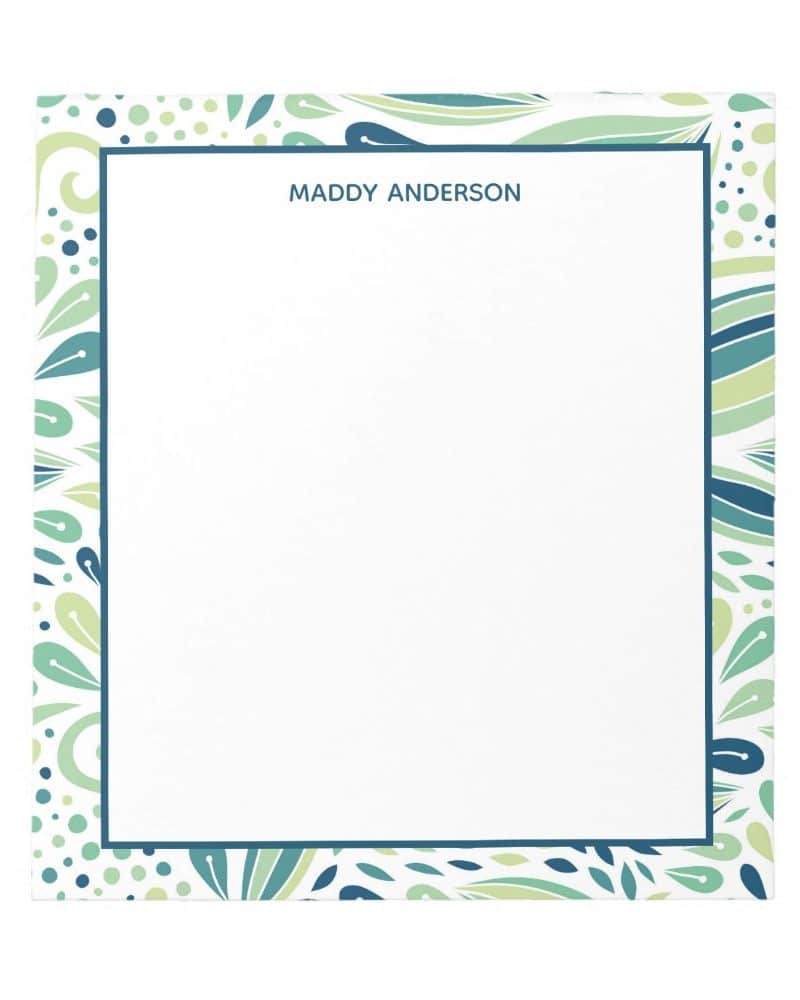 Personalized notepad with a teal and green leaf pattern border.