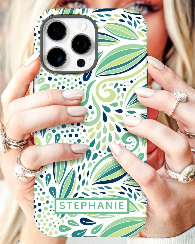 A woman's hands hold a phone case with a green and white floral design and the name Stephanie.