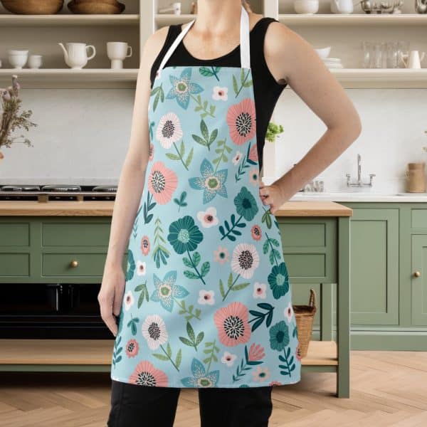 A Person Wearing A Light Blue Apron With A Floral Pattern.