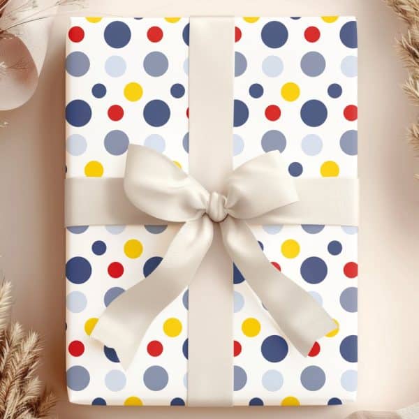 Gift Box With A Polka Dot Pattern In Blue, Red, And Yellow, Tied With A Cream-Colored Ribbon.