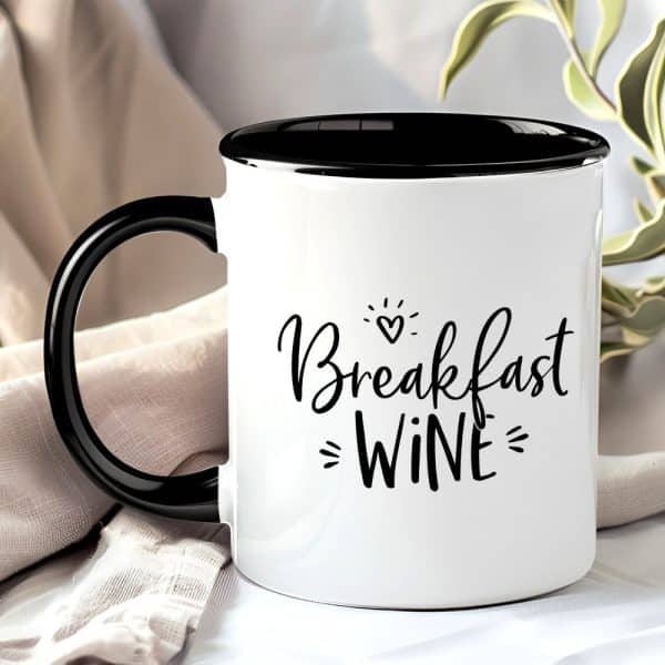White Mug With Black Handle And Interior, Displaying The Text Breakfast Wine In A Stylized Font.