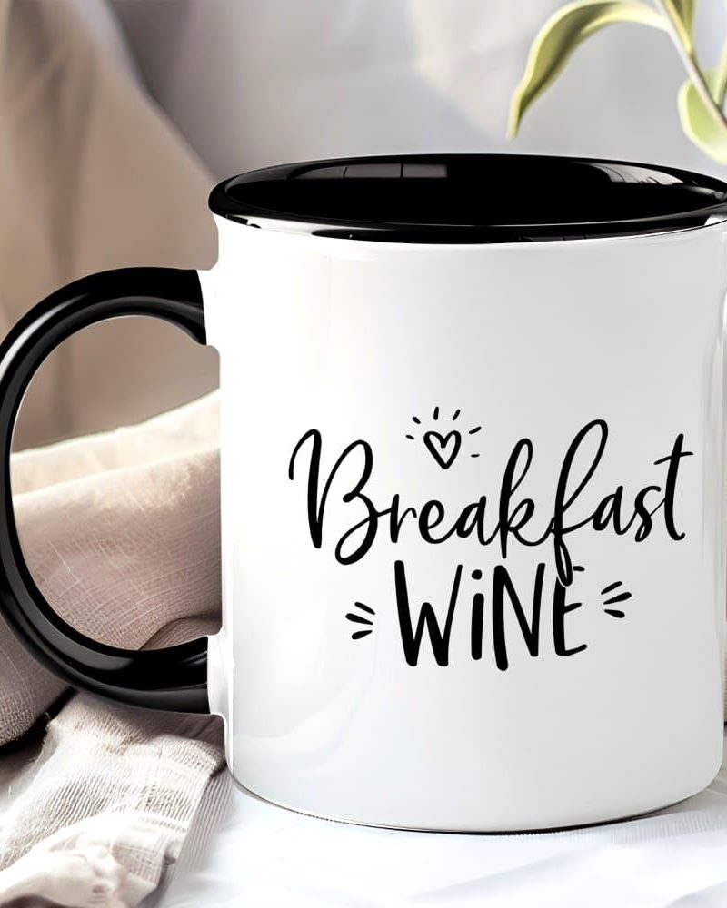 White mug with black handle and interior, displaying the text Breakfast Wine in a stylized font.
